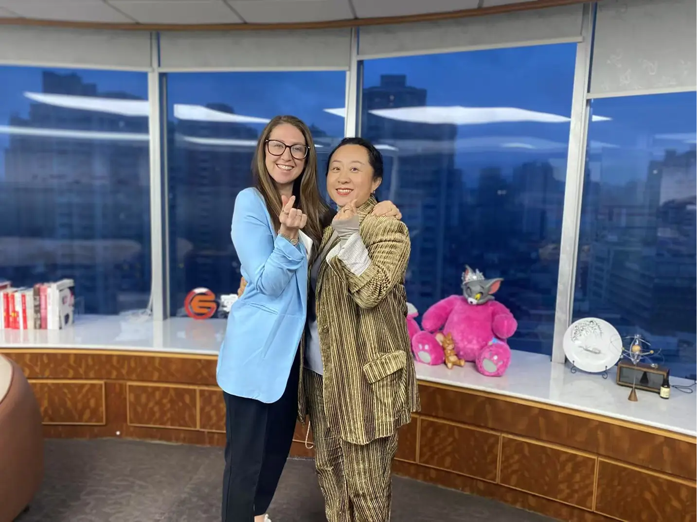 Two members of the Totally Teach team in an office overlooking the city